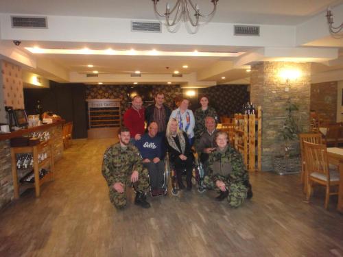 a group of people posing for a picture in a room at Hotel Centrum Prizren in Prizren