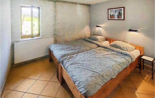 a bedroom with a bed in a room with a window at Lovely Home In Saint-Félix-De-L'héras in Saint-Félix-de-lʼHéras