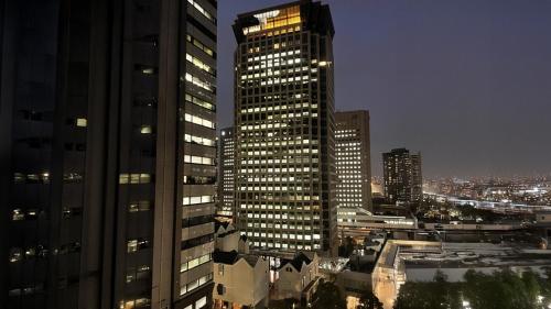 a city skyline with tall buildings at night at Toyoko Inn Tokyo Shinagawa Konan-guchi Tennozu Isle in Tokyo