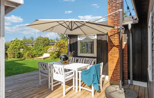 a patio with a table and an umbrella at Stunning Home In Nykøbing Sj With Wifi in Nykøbing Sjælland