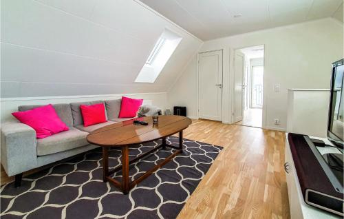 a living room with a couch and a table at Stunning Home In Båstad With Wifi in Båstad
