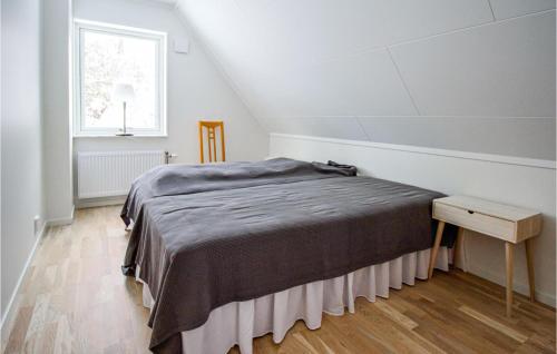 a bedroom with a bed and a window at Stunning Home In Båstad With Wifi in Båstad