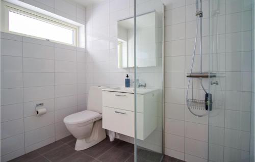 a white bathroom with a toilet and a shower at Stunning Home In Båstad With Wifi in Båstad