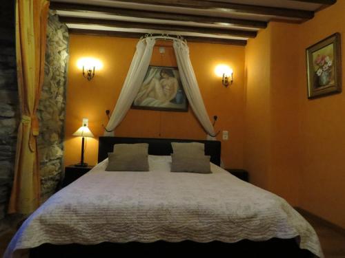 a bedroom with a large bed with a canopy at B&B Nord Sud in Salmchâteau