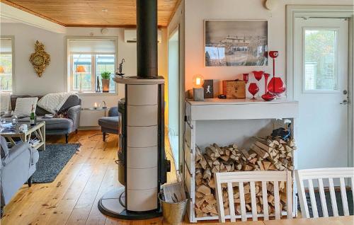 a living room with a wood burning fireplace at Nice Home In Hjältevad With Sauna in Hjältevad