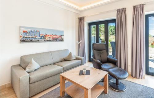 a living room with a couch and a table and a chair at Skipper in Binz
