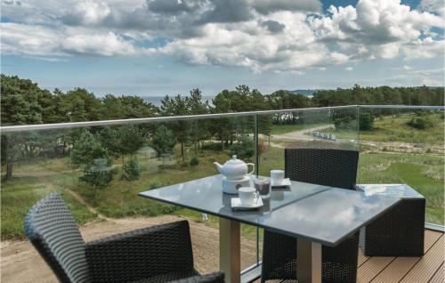a table and chairs on a balcony with a view at Penthouse Cloud in Binz