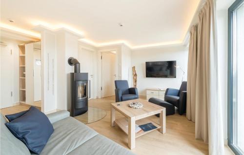 a living room with a couch and a fireplace at Penthouse Cloud in Binz