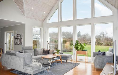 a living room with a couch and a table at Nice Home In Kivik With Wifi in Kivik