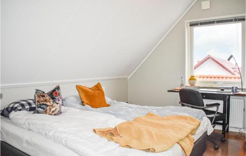 a bed in a room with a desk and a window at Nice Home In Kivik With Wifi in Kivik