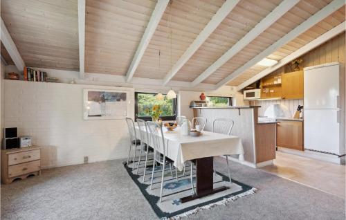 a kitchen with a table and chairs in a room at Holiday Home Gl Strandvej Henne X in Henne Strand