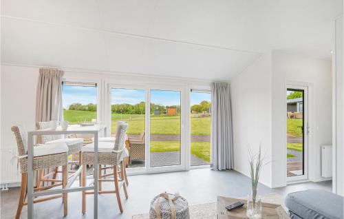 a white living room with a table and chairs at Chalet 8 Am See in Süsel