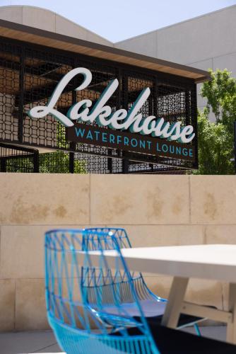 a blue chair sitting in front of a table at Omni Las Colinas Hotel in Irving