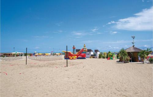 a playground on a beach with a plane on the sand at Pigne in Rosolina Mare