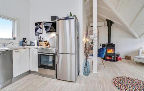 a kitchen with a stainless steel refrigerator and a stove at Beautiful Home In Karrebæksminde in Karrebæksminde