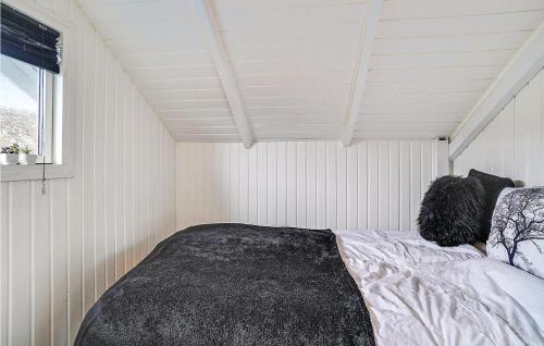 a bedroom with a bed in a white room at Beautiful Home In Karrebæksminde in Karrebæksminde