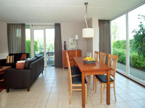a kitchen and living room with a table and chairs at Pet-Friendly Getaway in Heel