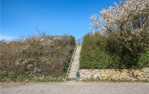 a set of stairs with a stone wall and trees at Stunning Apartment In Samsø With Wifi in Kolby Kås