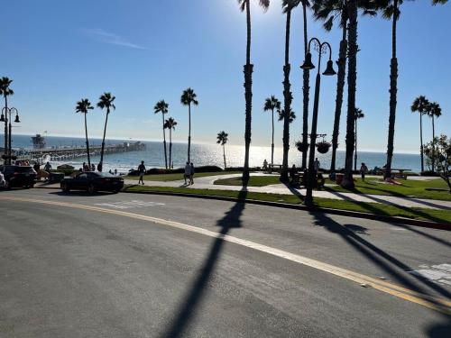 a street with palm trees and a beach with the ocean at Walk to Beach - KING Apt In #1 Area - AB in San Clemente