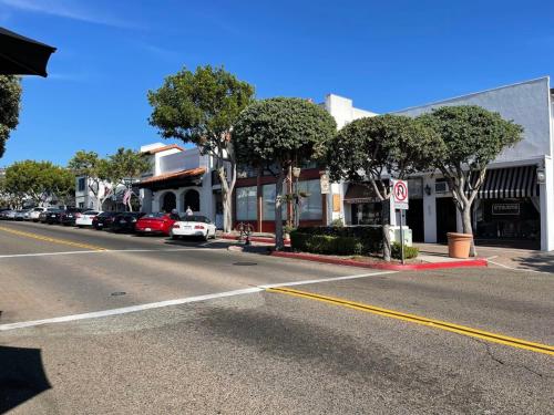 a street with cars parked in front of a building at Walk to Beach - KING Apt In #1 Area - AB in San Clemente