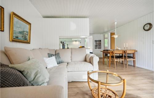 a living room with a couch and a table at Holiday Home Fyrvej Rømø Iii in Rømø