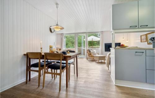a kitchen and dining room with a table and chairs at Holiday Home Fyrvej Rømø Iii in Rømø