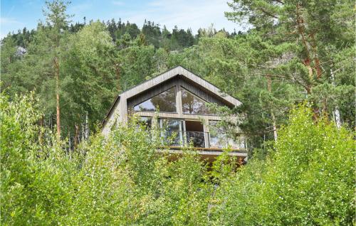 a small house in the middle of a forest at Nice Home In Treungen With Kitchen in Treungen
