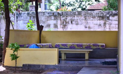 a bench sitting on the side of a wall at Arne's Place in Arugam Bay
