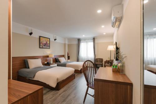 Postel nebo postele na pokoji v ubytování An Nguyen Boutique Hotel
