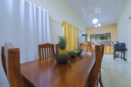 a dining room table with a plant on top of it at La Casa Amarilla in Fortuna