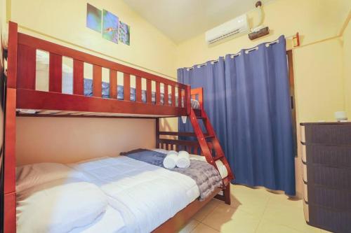 a bedroom with two bunk beds and a ladder at La Casa Amarilla in Fortuna