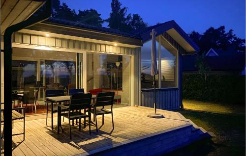 a patio with a table and chairs on a deck at Lovely Home In Farhult With Kitchen in Farhult