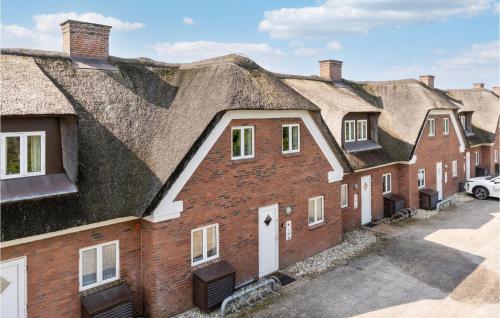 a row of houses with their roofs at Holiday Home Horns Bjerge 4, L Blåvand Vi in Blåvand