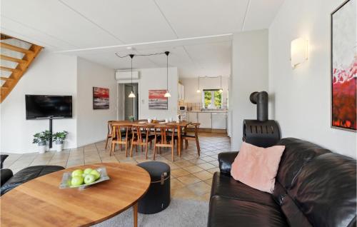 a living room with a couch and a table at Holiday Home Horns Bjerge 4, L Blåvand Vi in Blåvand