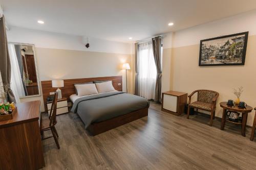 Postel nebo postele na pokoji v ubytování An Nguyen Boutique Hotel