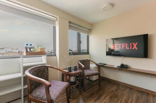a waiting room with a desk and chairs and a television at An Nguyen Boutique Hotel in Hanoi