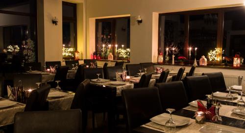 a restaurant with tables and chairs and christmas lights at Transylvanian Inn in Bran