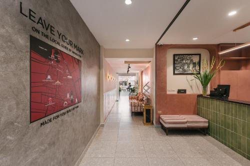 a lobby of a restaurant with a sign on the wall at An Nguyen Boutique Hotel in Hanoi