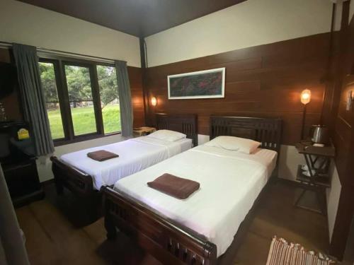 Una cama o camas en una habitación de Phutawan Pundao