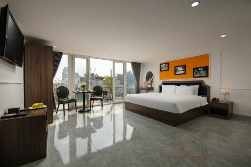 a hotel room with a bed and a table and chairs at Dream Premium Hotel & Spa in Hanoi