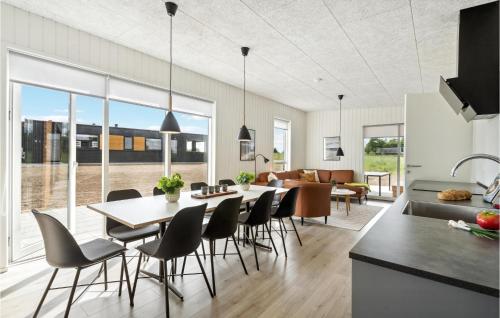 a kitchen and living room with a table and chairs at Awesome Home In Løgstrup With Kitchen in Løgstrup