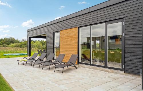 a group of chairs sitting on a patio at Awesome Home In Løgstrup With Kitchen in Løgstrup