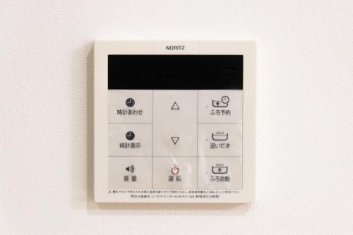 an electronic thermometer on a wall with the words north on it at 太宰府 月光の宿 MoonLight inn Free parking 4LDK一軒家 駐車場2台付き in Dazaifu