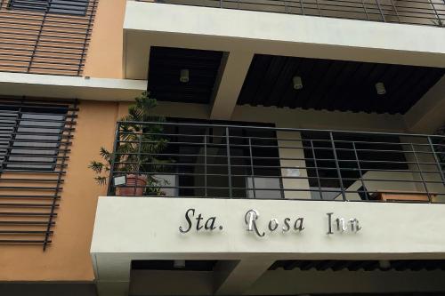 a building with a balcony with a sign on it at Sta Rosa Inn Iloilo powered by Cocotel in Iloilo City