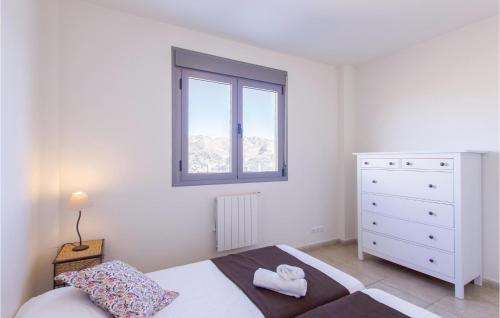 a white bedroom with a bed and a window at 4 Bedroom Awesome Home In Cómpeta in Árchez