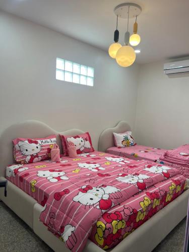 a bedroom with a bed with hello kitty pillows at Pani House Hatyai 5 in Hat Yai
