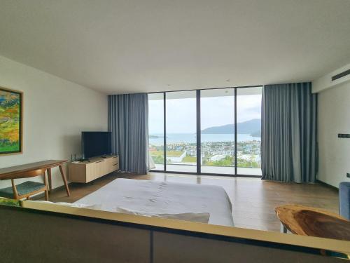 a large room with a bed and a large window at Anh Nguyen Oceanfront Luxury Villas Nha Trang in Nha Trang