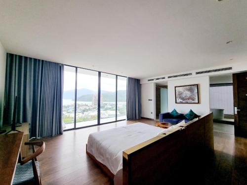 a bedroom with a large bed and a large window at Anh Nguyen Oceanfront Luxury Villas Nha Trang in Nha Trang