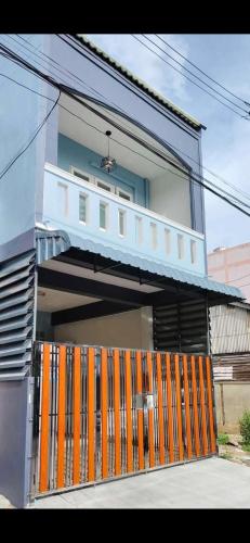 a house with an orange gate in front of it at Pani House Hatyai 5 in Hat Yai