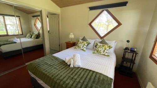 a bedroom with a large bed with towels on it at Rangers 2 'Morgan' in Mount Hotham